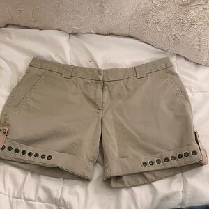 Tan shorts with eyelet detailing and pink interior detail